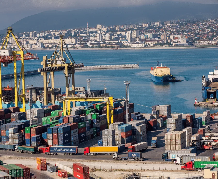 Large container ship loading full container loads (FCL) at a port for international freight forwarding