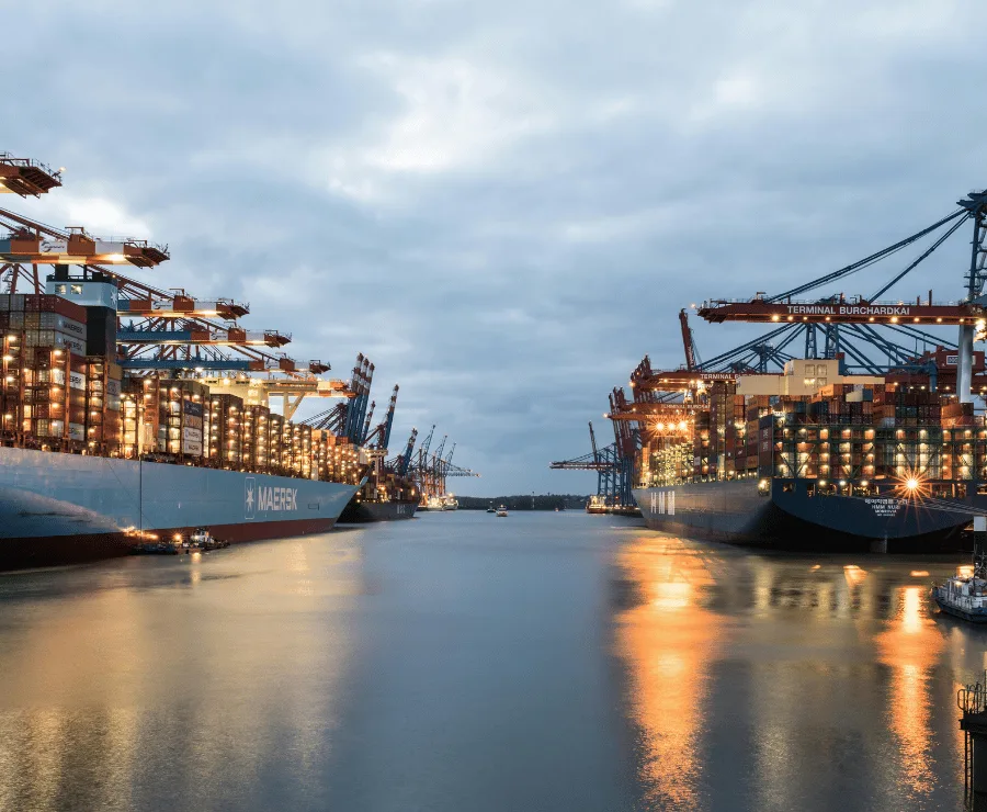 Full container load (FCL) freight forwarding with stacked cargo containers at port